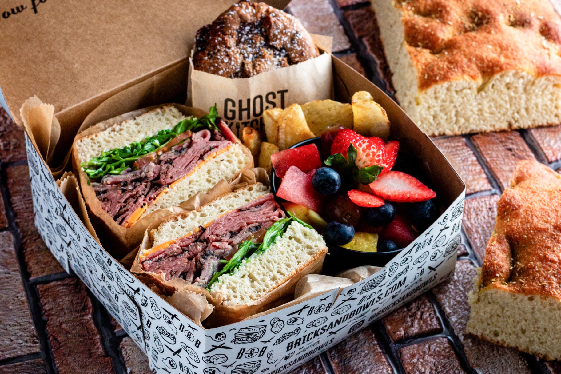 Boxed combo with focaccia sandwich, fruit, chips and cookie