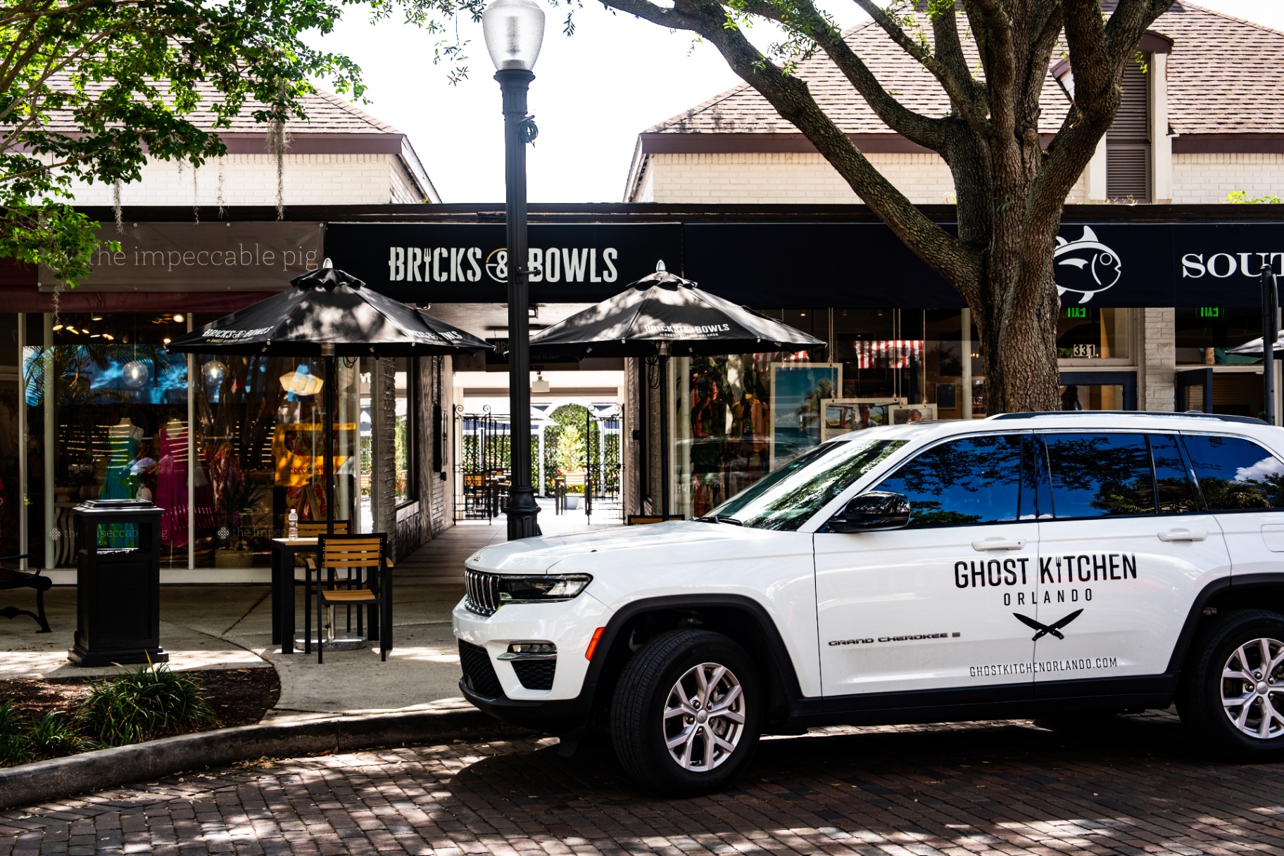 Bricks & Bowls storefront with Ghost Kitchen Orlando vehicle parked out front